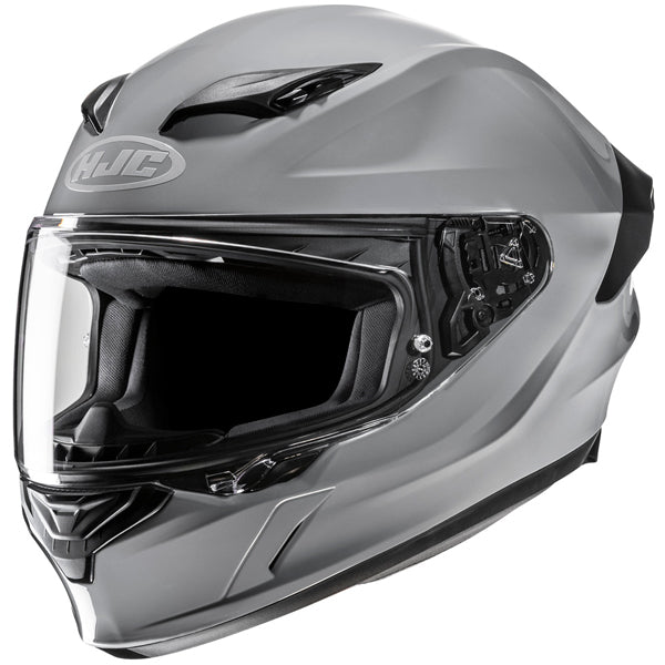 810017703 | A sleek, modern motorcycle helmet in matte silver with black accents, featuring a clear visor, aerodynamic design, and ventilation vents on top, set against a plain white background. The helmet has a prominent logo on the front, with detailed inner padding visible through the open visor, and a streamlined shape emphasizing safety and style. | Available at BTO Sports - alternate view
