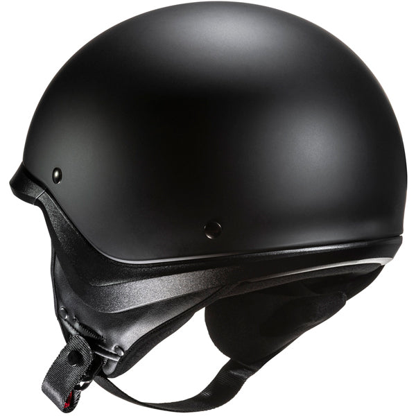 822020503 | A sleek, matte black motorcycle helmet with a smooth, rounded exterior and a slightly textured lower edge, featuring a black chin strap with a quick-release buckle, set against a plain white background. The helmet has small, subtle rivets on the sides and a minimalist design, emphasizing safety and modern style. | Available at BTO Sports