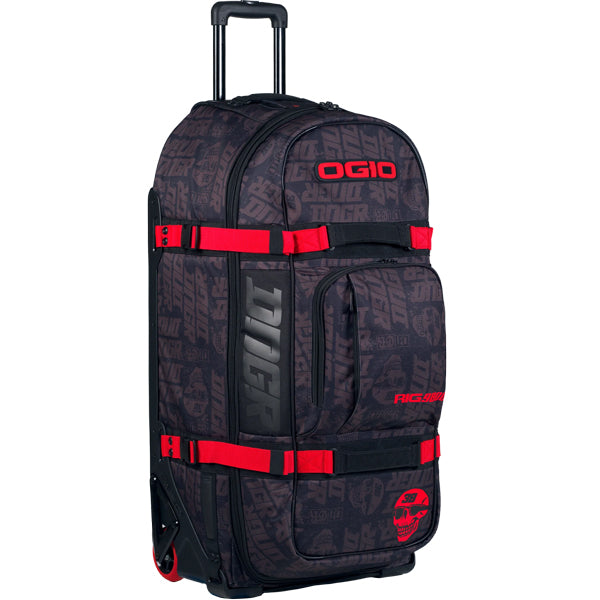 Straight-on angled view of OGIO RIG 9800 DNGR X gear bag standing upright in black DNGR print with bold red OGIO logo, red straps around the body, and wheel housing at the base, SKU 80100025 | Available at BTO Sports