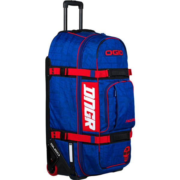 Angled upright view of the blue OGIO RIG 9800 DNGR X bag showing red straps, front storage pocket, bold OGIO logo on the top panel, and DNGR side branding. SKU 80100024 | Available at BTO Sports