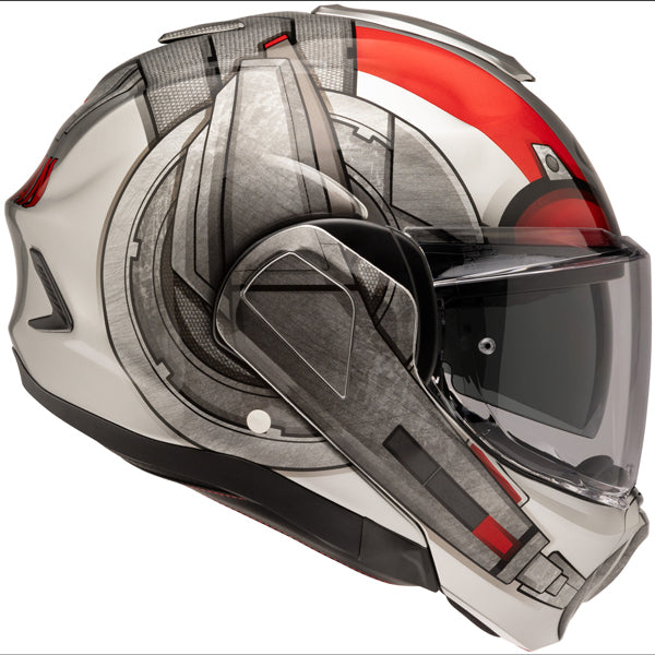 A modern motorcycle helmet with a sleek aerodynamic design, primarily white with black, red, and gray accents, featuring a clear visor, textured surface details, and angular lines. The helmet has a prominent red stripe on the top and side, with black vents and a streamlined shape that suggests high performance. It is photographed against a plain white background, with soft lighting highlighting its glossy finish and contours, giving it a professional and sporty appearance.