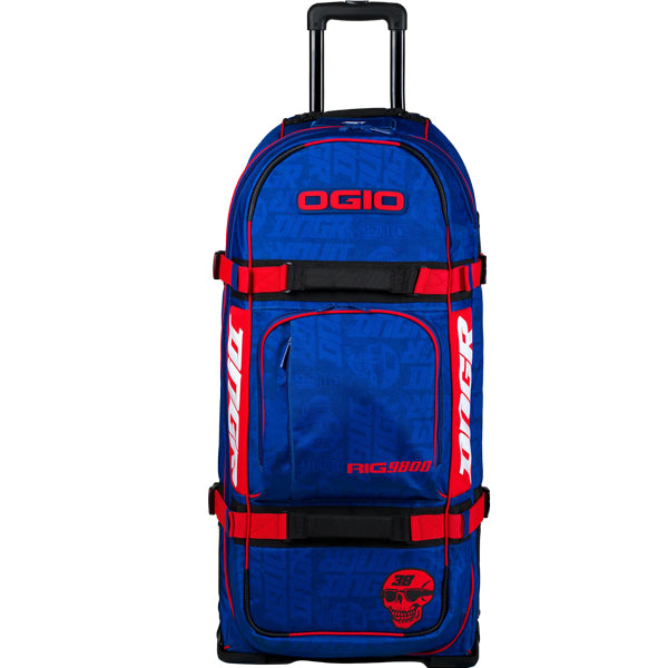 Straight front view of the blue OGIO RIG 9800 DNGR X gear bag with OGIO logo, red straps, large front pocket, and DNGR skull graphic at the bottom. SKU 80100024 | Available at BTO Sports