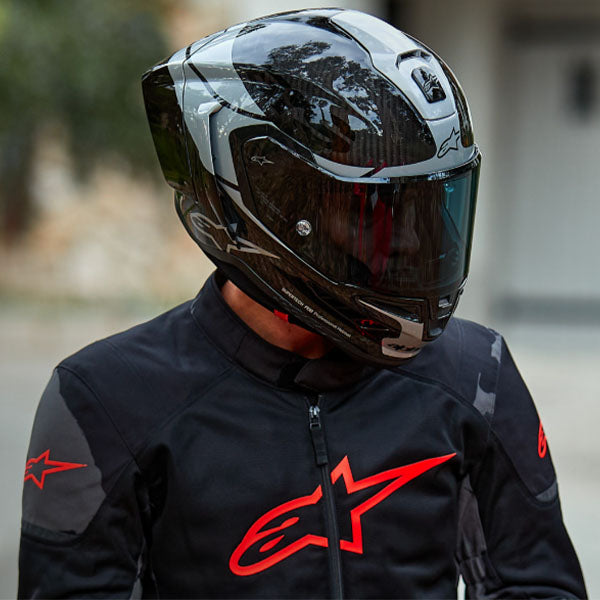 Carbon/Silver/Black product view, lightweight off‑road motorcycle helmet with ventilation and impact protection