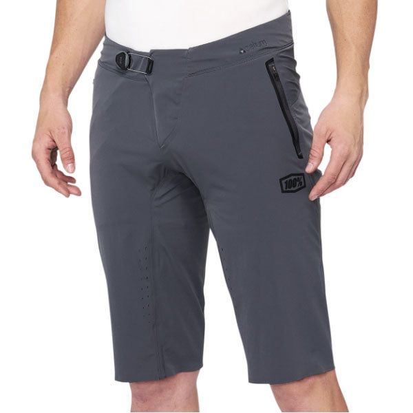 Studio photo showcasing 100%, Celium Short (MTB), Shorts, SKU 50010049, color options Black, Charcoal, sizes 28–38, Designed for Mountain Bike, BMX and E-Bike riders