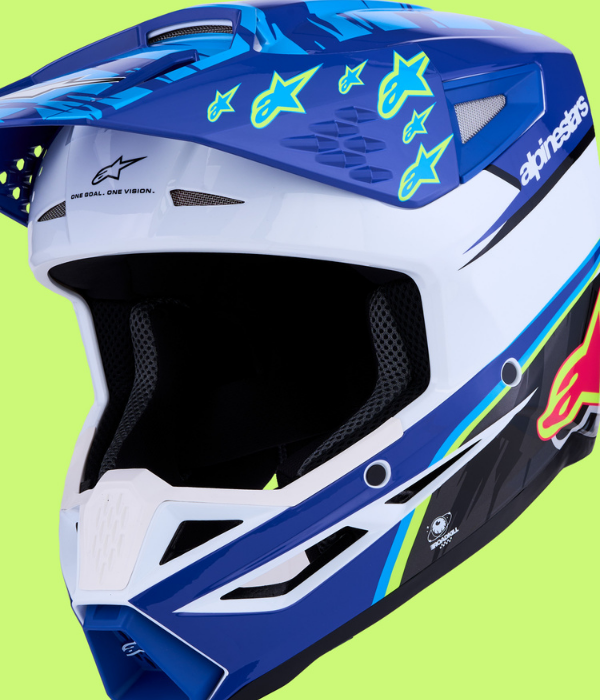 Close-up of the Alpinestars Supertech S-M10 motocross helmet in blue, white, and fluorescent yellow graphics collection