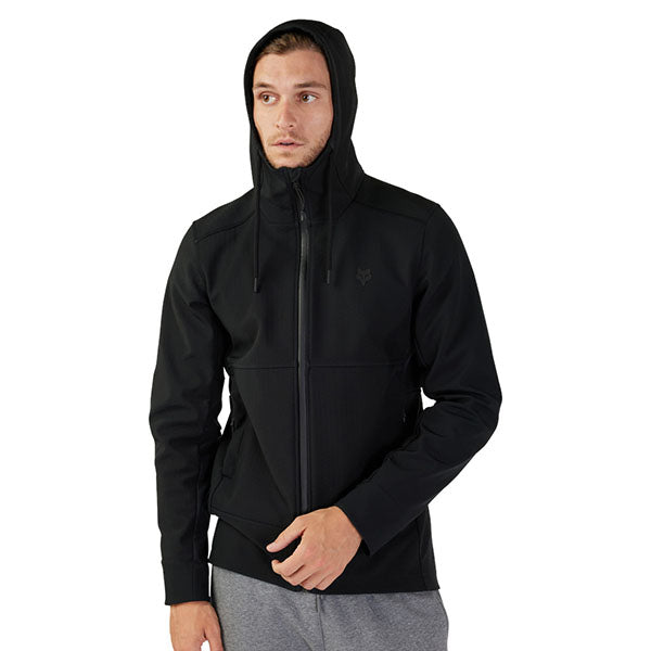 Side view of model wearing Pit Jacket in Black, SKU 33688-001, highlighting articulated sleeves and drop tail hem