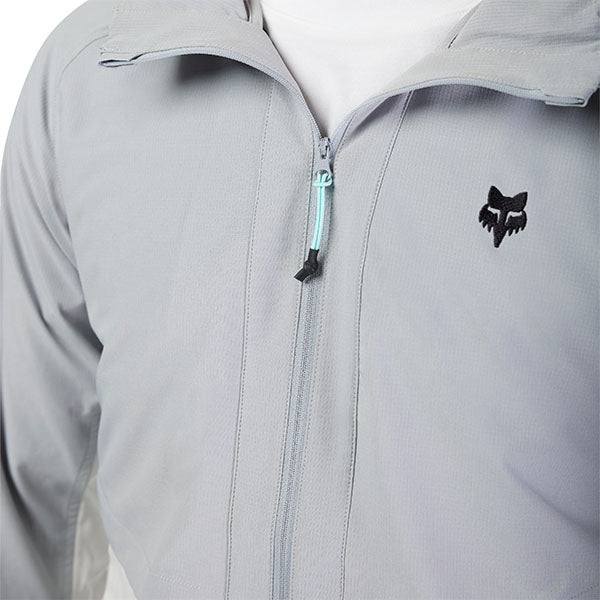 Detail view of Fox logo and zippered pocket on Survivalist Windbreaker in Dark Vintage, SKU 32616-172