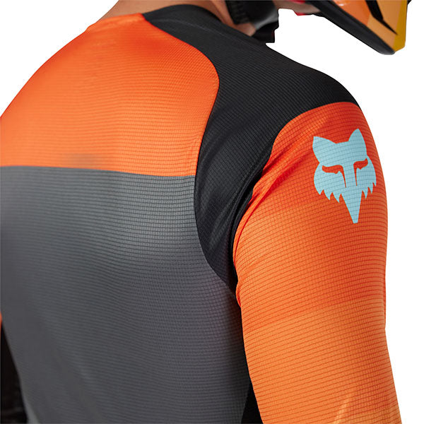 Shoulder and sleeve close-up of Fox Racing Flexair Grid Jersey in Black and Orange (SKU: 33539-016), showing bonded cuff and fabric texture