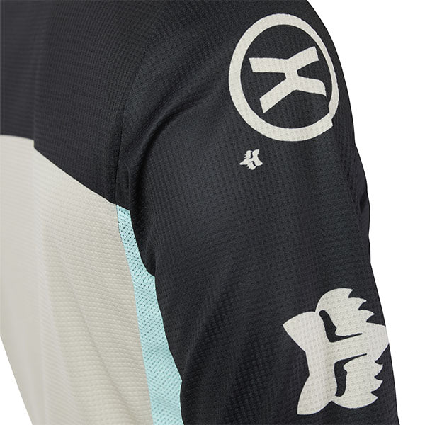 Side angle of Fox Racing 180 Hello Future Jersey in Black and Blue (SKU: 33534-001), emphasizing ergonomic cut