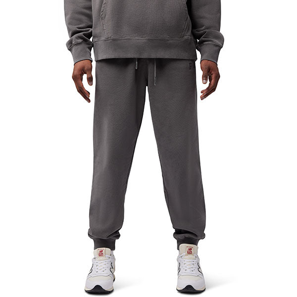 Side view of model wearing Wordmark Joggers in Pewter, SKU 33146-052, highlighting fleece material and embroidery
