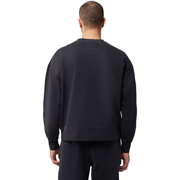 Lifestyle image of model wearing Fox Racing Wordmark Crew Pullover in Black, SKU 33142-001, styled with joggers