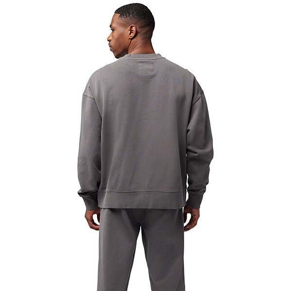 Lifestyle image of model wearing Fox Racing Wordmark Crew Pullover in Pewter, SKU 33142-052, paired with matching joggers