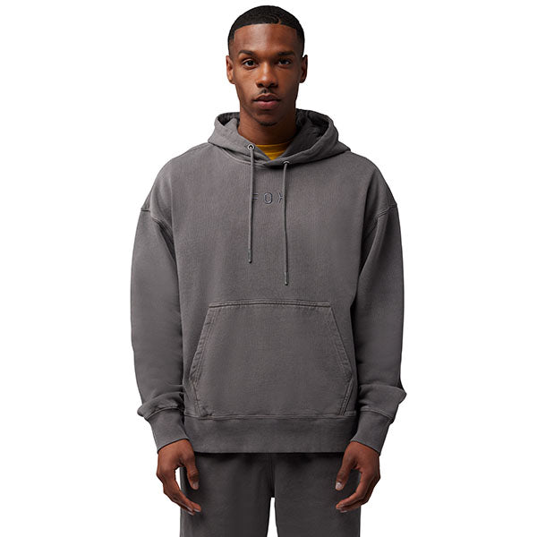 Side view of model wearing Wordmark Hoodie in Pewter, SKU 32865-052, highlighting kangaroo pocket and ribbed hem