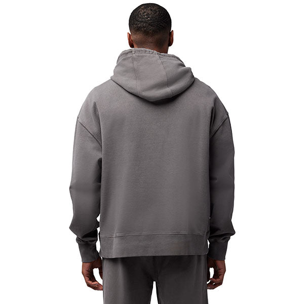 Lifestyle image of model wearing Fox Racing Wordmark Hoodie in Pewter, SKU 32865-052, paired with matching joggers