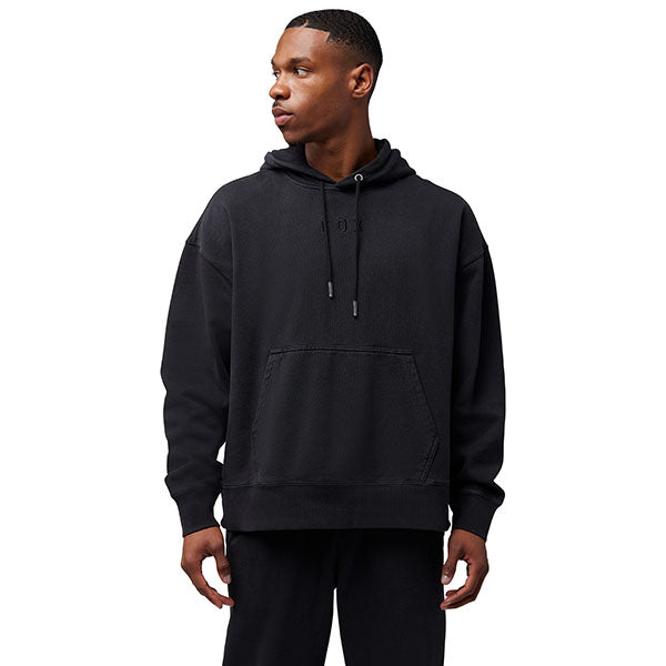 Side view of model wearing Wordmark Hoodie in Black, SKU 32865-001, highlighting drawcord hood and ribbed cuffs