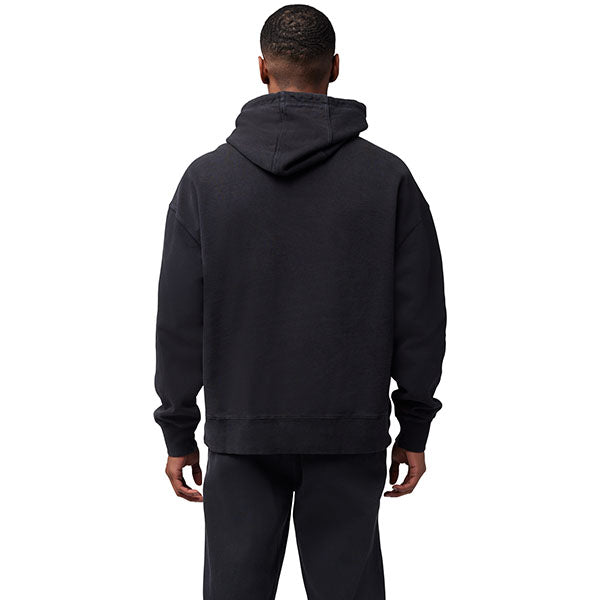 Lifestyle image of model wearing Fox Racing Wordmark Hoodie in Black, SKU 32865-001, styled with joggers