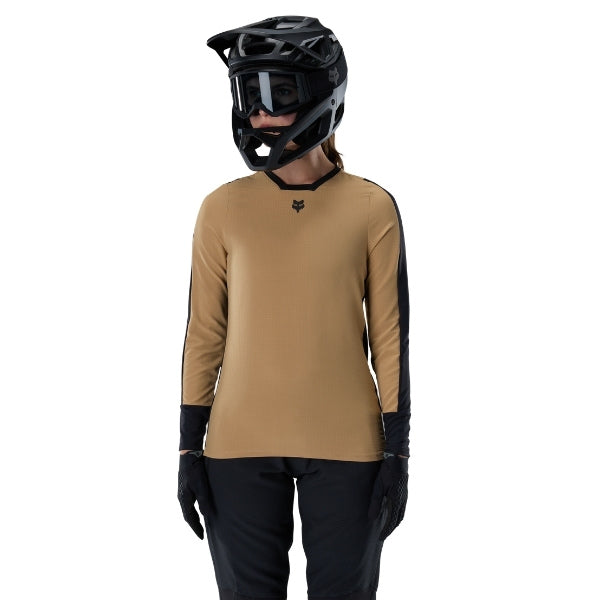 Fox Racing Defend Thermal Jersey (MTB) (Womens) in Brown Sugar, close-up of the sleeve graphic and cuff, with the printed Fox artwork, mesh-knit texture, reinforced seam lines, and shaped cuff or hem. Available options—Color: Brown Sugar, Black; Size: XS, SM, MD, LG, XL. SKU 33787-614-XL. UPC 198571109885.