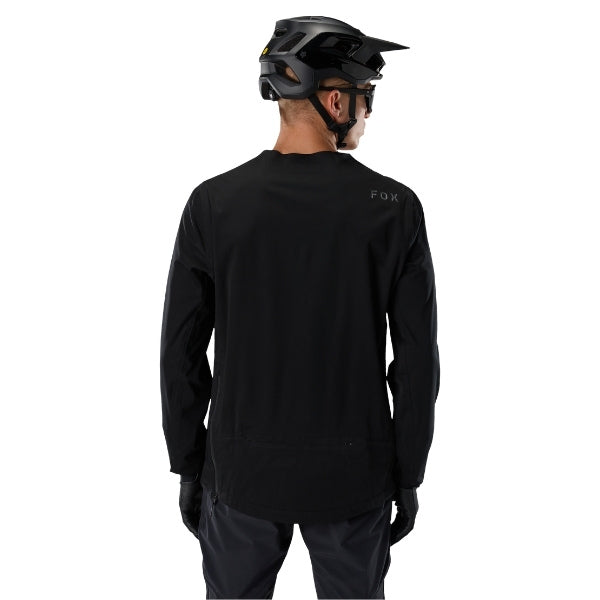 Fox Racing Flexair Water Pullover (MTB) in Black, full modeled rear view, with the plain black back panel, long sleeves, small upper-back Fox lettering, and curved rear hem. Available options—Color: Black; Size: SM, MD, LG, XL, 2X.