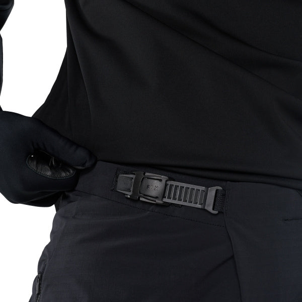 Fox Racing Flexair Fire Pants (MTB) in Black, close-up of the waist and hip panels, with the ratcheting waist adjuster, stretch yoke, shaped hip panel, and reinforced knee or thigh material. Available options—Color: Black, Nutmeg, Galaxy Blue; Size: 28, 30, 32, 34, 36, 38, 40. SKU 40142-001-32. UPC 198571106433.