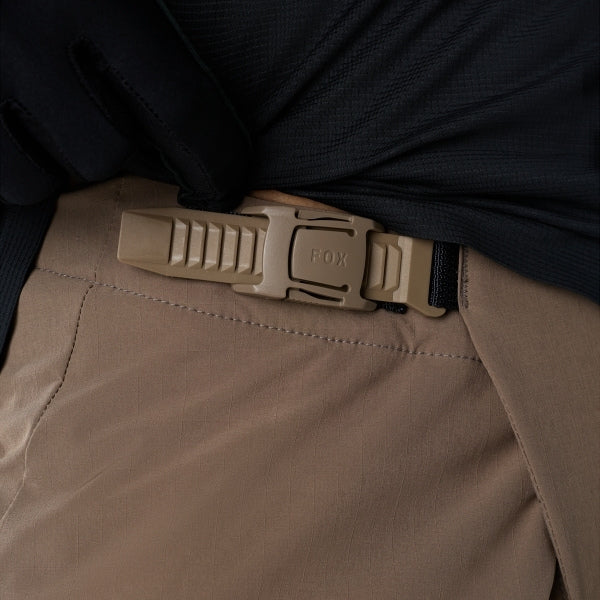 Fox Racing Flexair Fire Pants (MTB) in Nutmeg, close-up of the ratcheting waist closure, with the ratcheting waist adjuster, stretch yoke, shaped hip panel, and reinforced knee or thigh material. Available options—Color: Black, Nutmeg, Galaxy Blue; Size: 28, 30, 32, 34, 36, 38, 40. SKU 40142-512-34. UPC 198571117644.