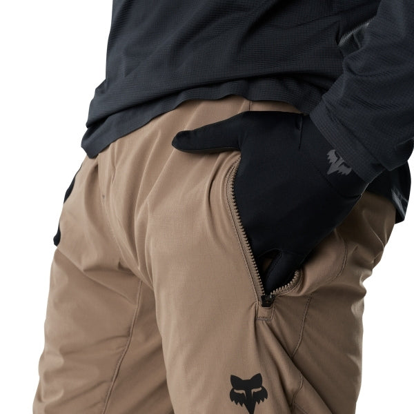 Fox Racing Flexair Fire Pants (MTB) in Nutmeg, close-up of the side thigh and knee panels, with the ratcheting waist adjuster, stretch yoke, shaped hip panel, and reinforced knee or thigh material. Available options—Color: Black, Nutmeg, Galaxy Blue; Size: 28, 30, 32, 34, 36, 38, 40. SKU 40142-512-36. UPC 198571117651.