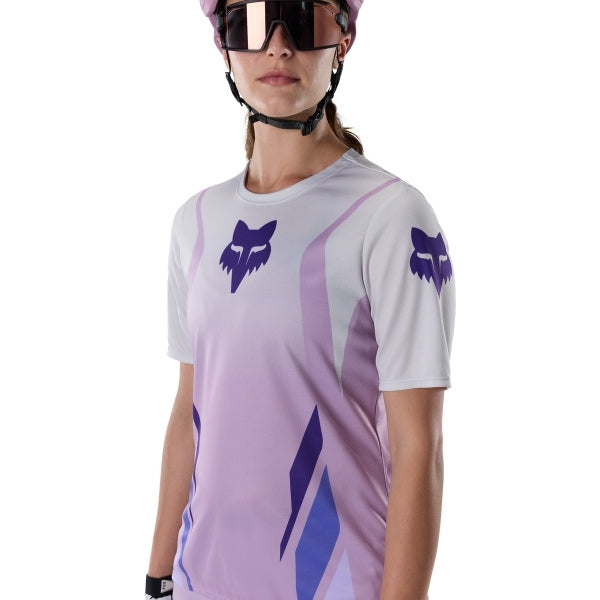 Fox Racing Ranger Foundry Jersey (MTB) (Womens) in Lavender Drift, modeled front three-quarter view, with the crew neck, long sleeves, contrasting shoulder and arm graphics, and extended rear hem on a rider. Available options—Color: Lavender Drift; Size: XS, SM, MD, LG, XL. SKU 40168-F07-M. UPC 198571115411.