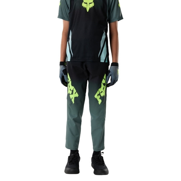 Fox Racing Ranger Foundry Pants (MTB) (Youth) in Sage, close-up of the side thigh and knee panels, with the ratcheting waist adjuster, stretch yoke, shaped hip panel, and reinforced knee or thigh material. Available options—Color: Sage; Size: Y-22, Y-24, Y-26, Y-28.