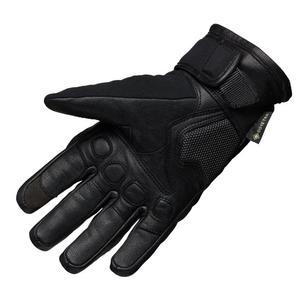 Fox Racing Bomber Pro Stealth GTX Gloves in Black, palm-side view, with the perforated palm, silicone finger grips, curved fingertips, and slip-on cuff. Available options—Color: Black; Size: SM, MD, LG, XL, 2X, 3X. SKU 33599-001-M. UPC 198571121511.