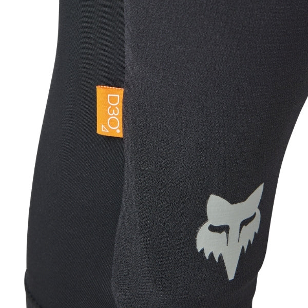 Fox Racing Enduro Knee Sleeve (Youth) in Black, close-up of the Fox logo panel, with the flexible black sleeve, molded impact pad, mesh ventilation, elastic cuff, and Fox logo. Available options—Color: Black.
