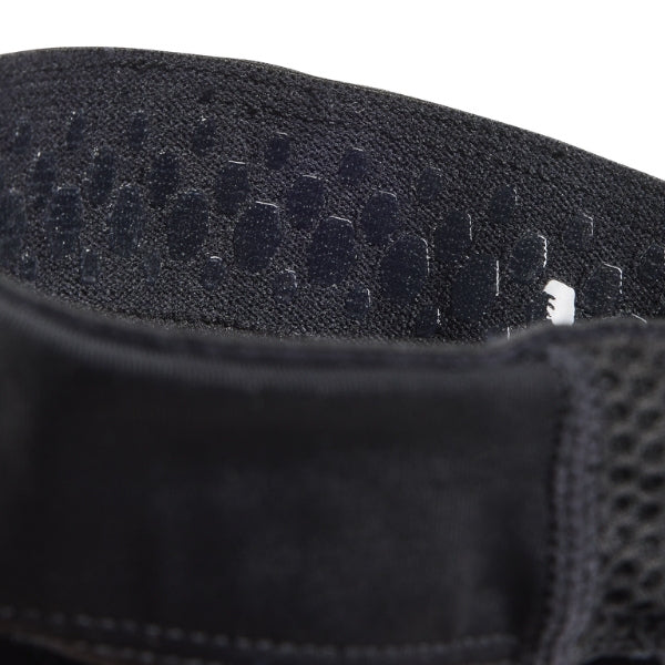 Fox Racing Enduro Knee Sleeve (Youth) in Black, close-up of the elastic upper cuff, with the flexible black sleeve, molded impact pad, mesh ventilation, elastic cuff, and Fox logo. Available options—Color: Black. - alternate view