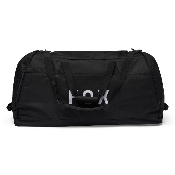 Fox Racing Podium Duffle in Red, long-side view, with the main zippered compartment, reinforced base, carry handles, end pocket, wheels, and large Fox logo. Available options—Color: Black, Red, Blue Jewel. SKU 39031-003-OS. UPC 198571129975.