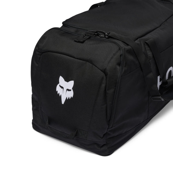 Fox Racing Podium Duffle in Blue Jewel, opposite long-side view, with the main zippered compartment, reinforced base, carry handles, end pocket, wheels, and large Fox logo. Available options—Color: Black, Red, Blue Jewel.