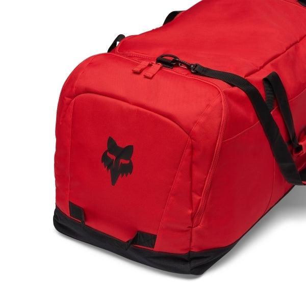 Fox Racing Podium Duffle in Blue Jewel, opposite long-side view, with the main zippered compartment, reinforced base, carry handles, end pocket, wheels, and large Fox logo. Available options—Color: Black, Red, Blue Jewel.