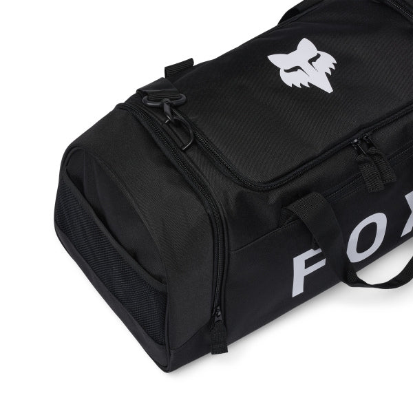 Fox Racing 180 Duffle in Orange, long-side view, with the main zippered compartment, reinforced base, carry handles, end pocket, wheels, and large Fox logo. Available options—Color: Black, Vivid Green, Orange. SKU 39035-009-OS. UPC 198571128817.