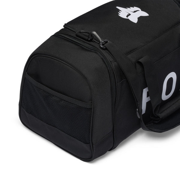 Fox Racing 180 Duffle in Orange, opposite long-side view, with the main zippered compartment, reinforced base, carry handles, end pocket, wheels, and large Fox logo. Available options—Color: Black, Vivid Green, Orange.