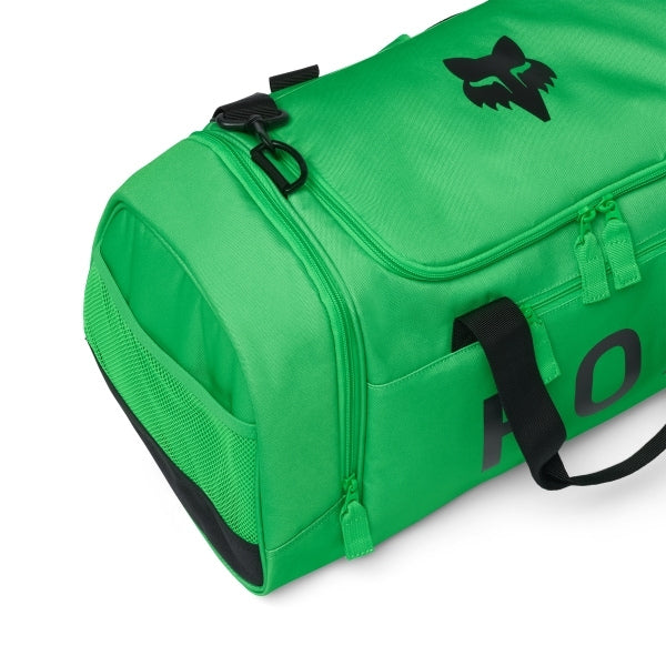Fox Racing 180 Duffle in Orange, long-side view, with the main zippered compartment, reinforced base, carry handles, end pocket, wheels, and large Fox logo. Available options—Color: Black, Vivid Green, Orange.