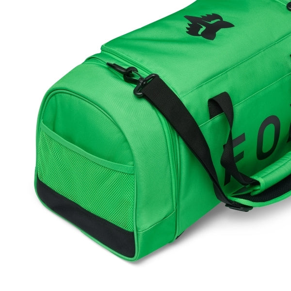 Fox Racing 180 Duffle in Orange, opposite long-side view, with the main zippered compartment, reinforced base, carry handles, end pocket, wheels, and large Fox logo. Available options—Color: Black, Vivid Green, Orange.