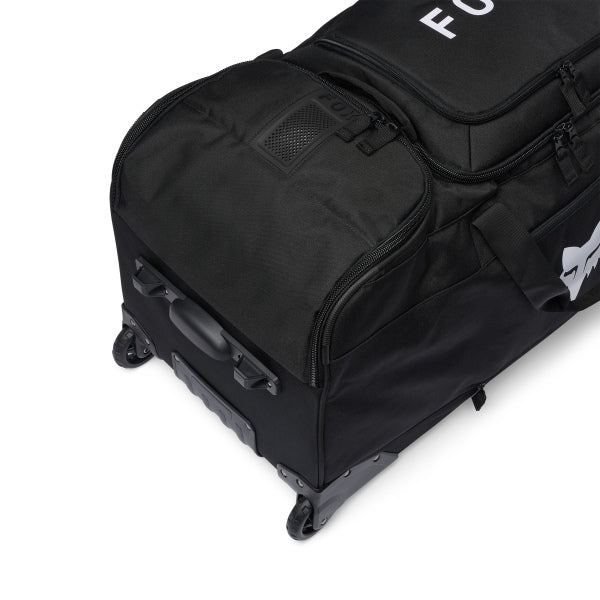 Fox Racing Shuttle Roller Bag in Midnight, long-side view, with the main zippered compartment, reinforced base, carry handles, end pocket, wheels, and large Fox logo. Available options—Color: Black, Pewter, Midnight. SKU 40539-329-OS. UPC 198571127087.