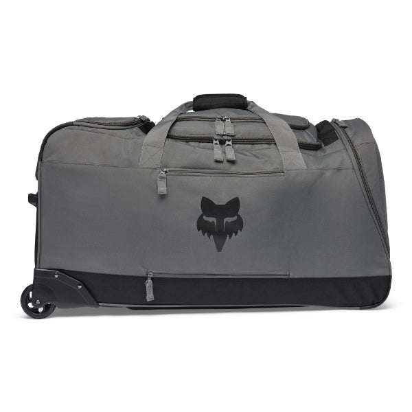 Fox Racing Shuttle Roller Bag in Midnight, three-quarter view of the wheeled base and zippered compartments, with the main zippered compartment, reinforced base, carry handles, end pocket, wheels, and large Fox logo. Available options—Color: Black, Pewter, Midnight.