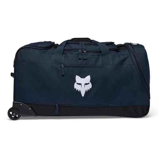 Fox Racing Shuttle Roller Bag in Midnight, three-quarter view of the wheeled base and zippered compartments, with the main zippered compartment, reinforced base, carry handles, end pocket, wheels, and large Fox logo. Available options—Color: Black, Pewter, Midnight.