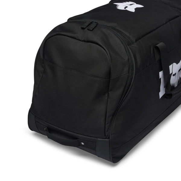 Fox Racing 180 Roller Bag in Midnight, opposite long-side view, with the main zippered compartment, reinforced base, carry handles, end pocket, wheels, and large Fox logo. Available options—Color: Black, Pewter, Midnight.