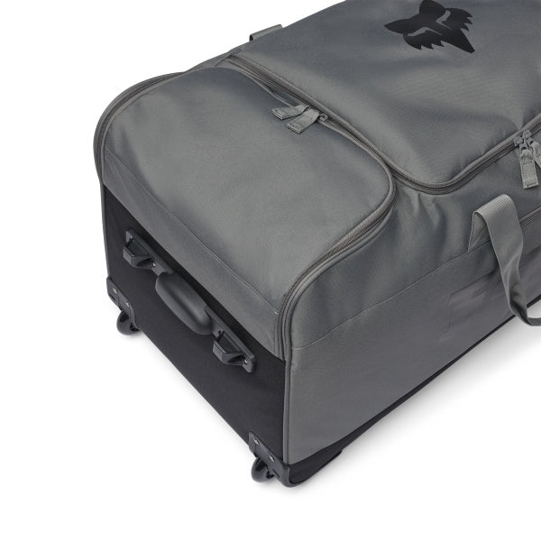 Fox Racing 180 Roller Bag in Midnight, long-side view, with the main zippered compartment, reinforced base, carry handles, end pocket, wheels, and large Fox logo. Available options—Color: Black, Pewter, Midnight.