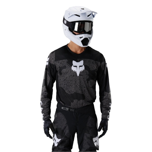 Fox Racing 180 BNKR Jersey in Black Camo, close-up of the sleeve graphic and cuff, with the printed Fox artwork, mesh-knit texture, reinforced seam lines, and shaped cuff or hem. Available options—Color: Black Camo; Size: XS, SM, MD, LG, XL, 2X. SKU 40649-247-XL. UPC 198571123348.