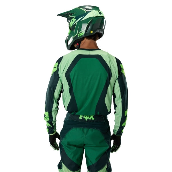 Fox Racing 180 Raid Jersey in Deep Fern, close-up of the lower hem and drop-tail panel, with the printed Fox artwork, mesh-knit texture, reinforced seam lines, and shaped cuff or hem. Available options—Color: Rust, Purple Lava, Deep Fern; Size: XS, SM, MD, LG, XL, 2X. SKU 40655-D10-2X. UPC 198571125052.