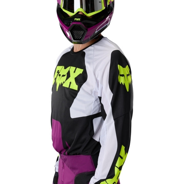 Fox Racing 180 Raid Jersey in Purple Lava, modeled front three-quarter view, with the crew neck, long sleeves, contrasting shoulder and arm graphics, and extended rear hem on a rider. Available options—Color: Rust, Purple Lava, Deep Fern; Size: XS, SM, MD, LG, XL, 2X. SKU 40655-E07-M. UPC 198571129241.