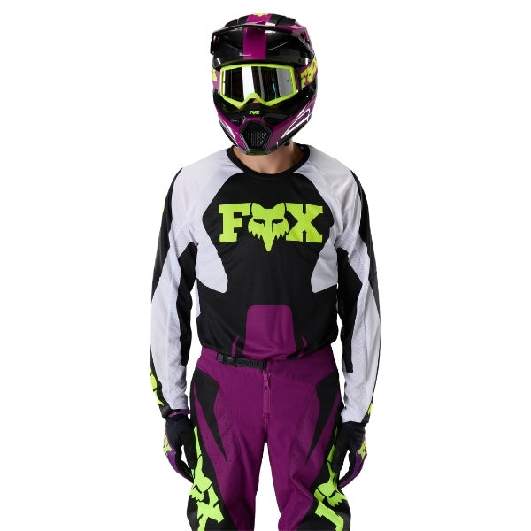 Fox Racing 180 Raid Jersey in Purple Lava, close-up of the sleeve graphic and cuff, with the printed Fox artwork, mesh-knit texture, reinforced seam lines, and shaped cuff or hem. Available options—Color: Rust, Purple Lava, Deep Fern; Size: XS, SM, MD, LG, XL, 2X. SKU 40655-E07-XL. UPC 198571129265.