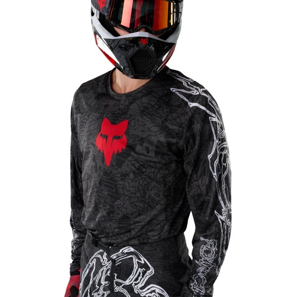Fox Racing 180 Abyss Jersey in Black, modeled front three-quarter view, with the crew neck, long sleeves, contrasting shoulder and arm graphics, and extended rear hem on a rider. Available options—Color: Black; Size: XS, SM, MD, LG, XL, 2X. SKU 40656-001-M. UPC 198571122280.