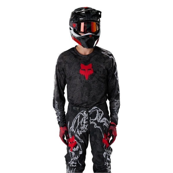 Fox Racing 180 Abyss Jersey in Black, close-up of the sleeve graphic and cuff, with the printed Fox artwork, mesh-knit texture, reinforced seam lines, and shaped cuff or hem. Available options—Color: Black; Size: XS, SM, MD, LG, XL, 2X. SKU 40656-001-XL. UPC 198571122303.