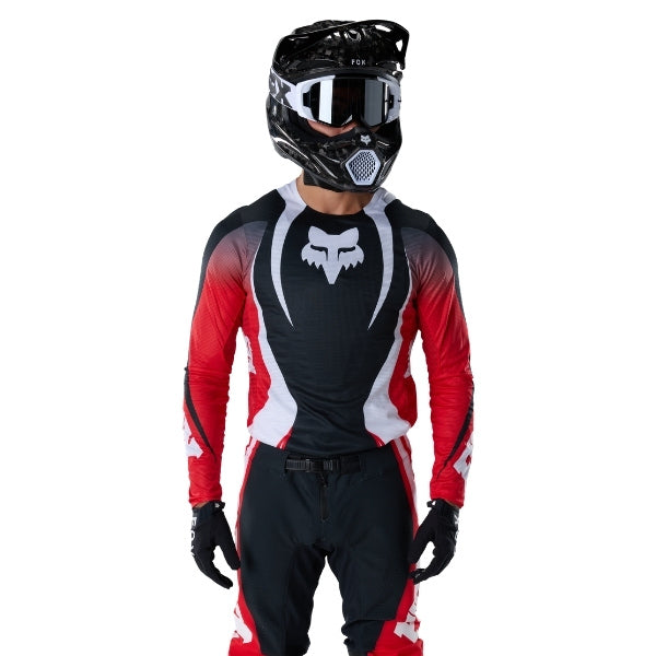 Fox Racing Flexair Thorn Jersey in Red, full modeled front view, with the crew neck, long sleeves, contrasting shoulder and arm graphics, and extended rear hem on a rider. Available options—Color: Black/White, Purple Lava, Red; Size: SM, MD, LG, XL, 2X.