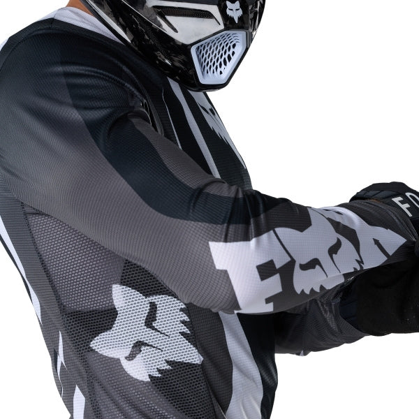 Fox Racing Flexair Thorn Jersey in Black/White, close-up of the chest and shoulder panels, with the printed Fox artwork, mesh-knit texture, reinforced seam lines, and shaped cuff or hem. Available options—Color: Black/White, Purple Lava, Red; Size: SM, MD, LG, XL, 2X. SKU 40658-018-XL. UPC 198571123751.